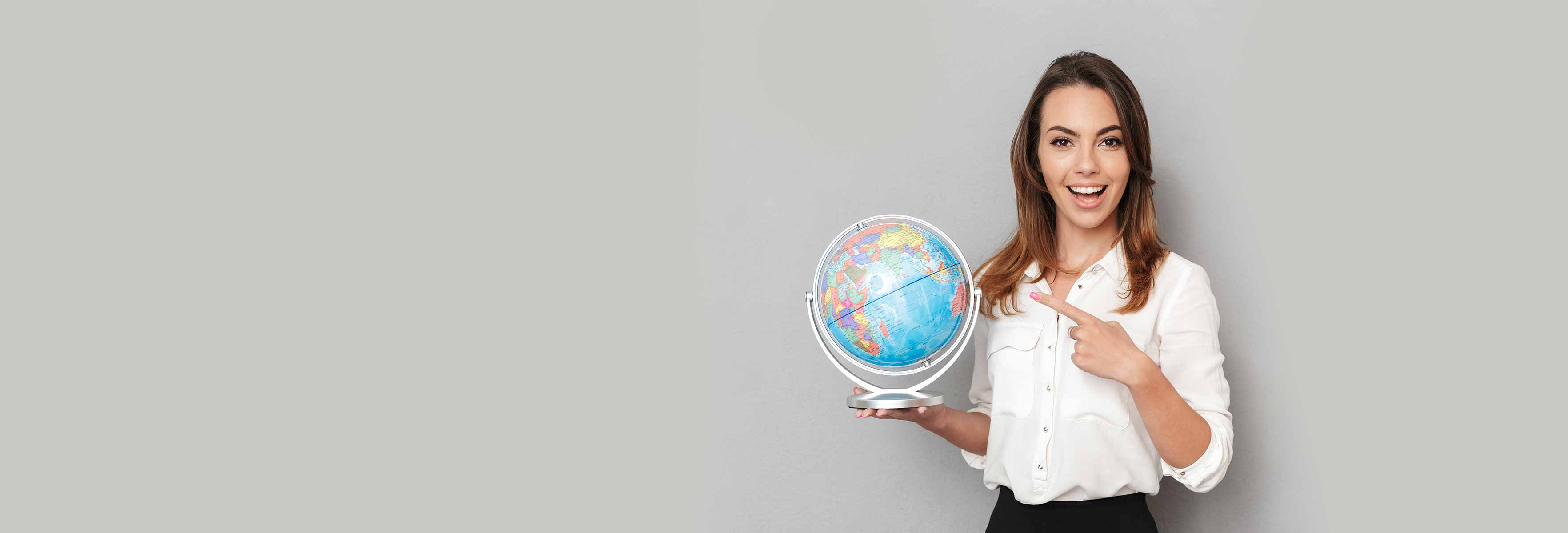 girl in white shirt pointing to  globe