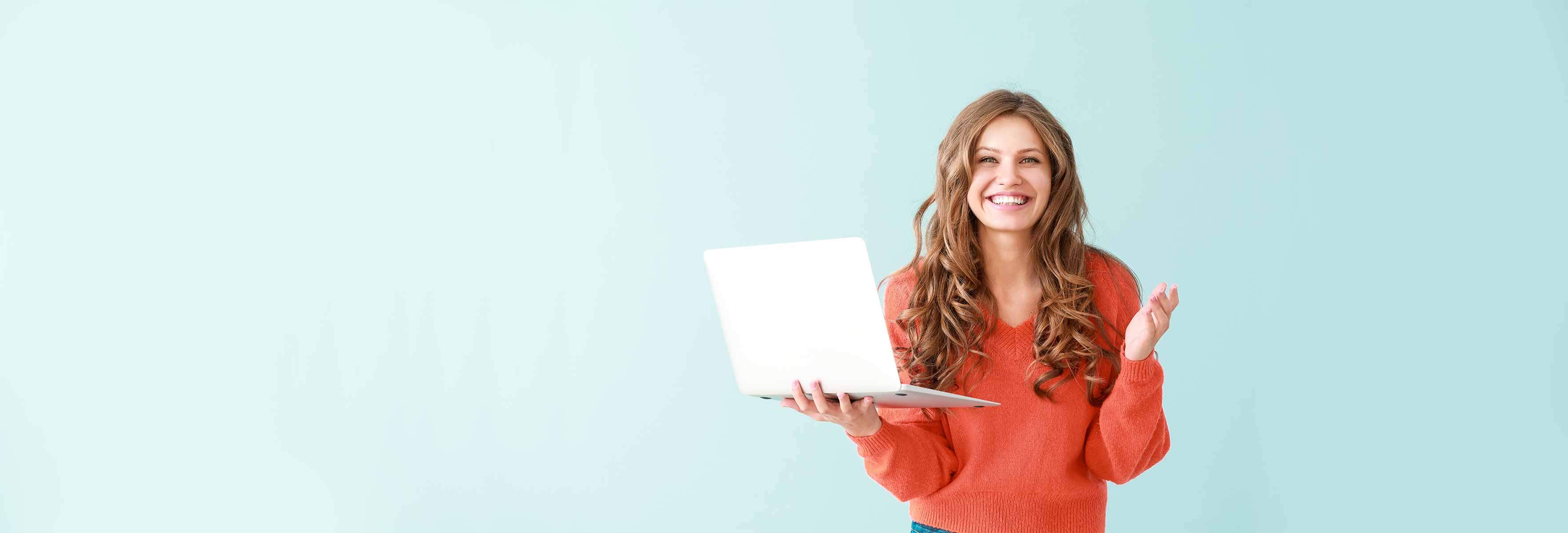 girl in red sweatshirt holding a laptop