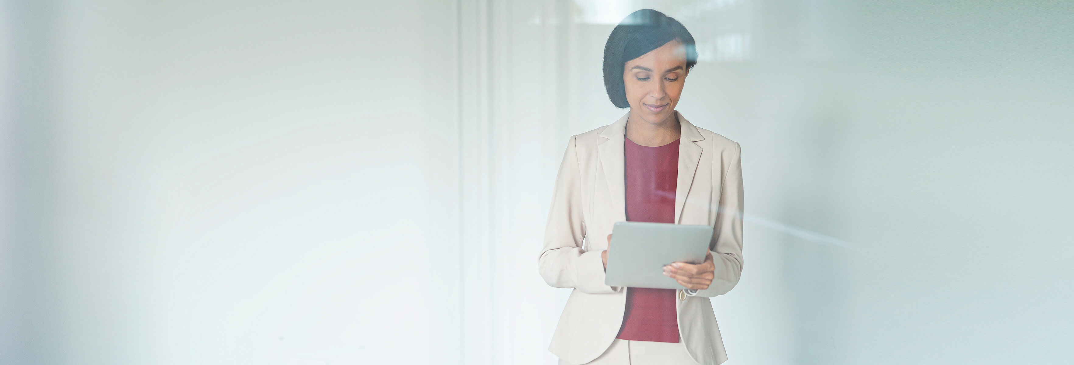 Smart dressed women holding a tablet