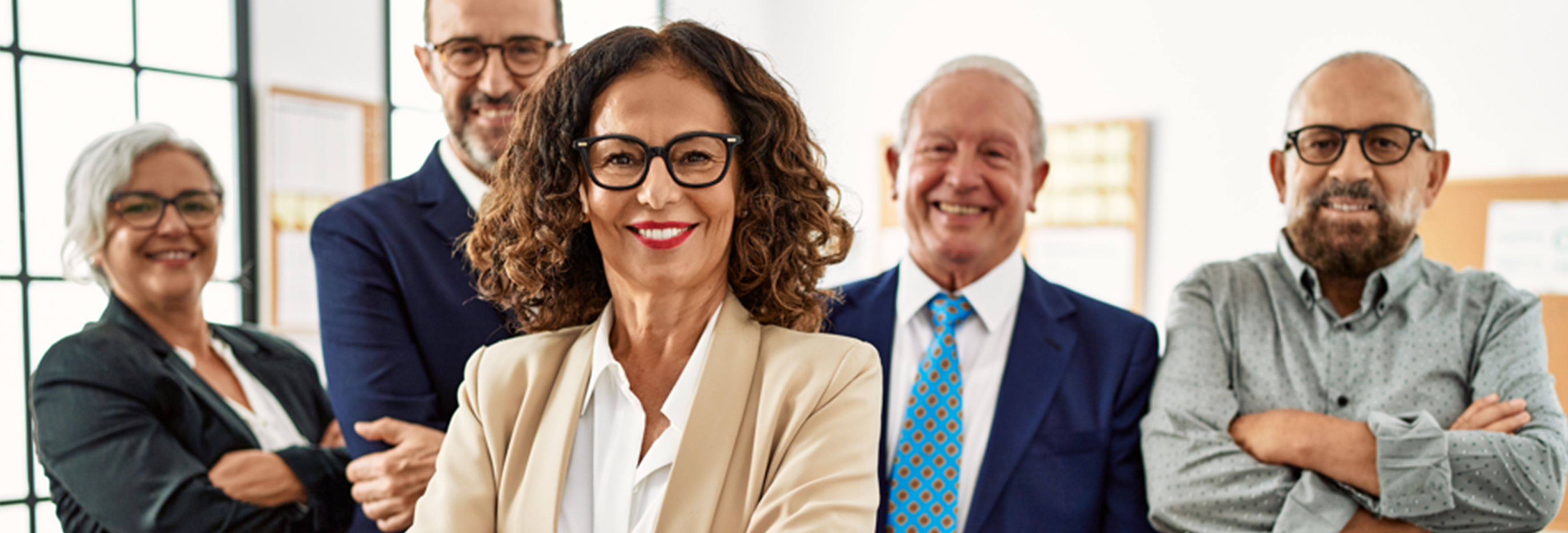 Smiling woman standing in front of her colleagues