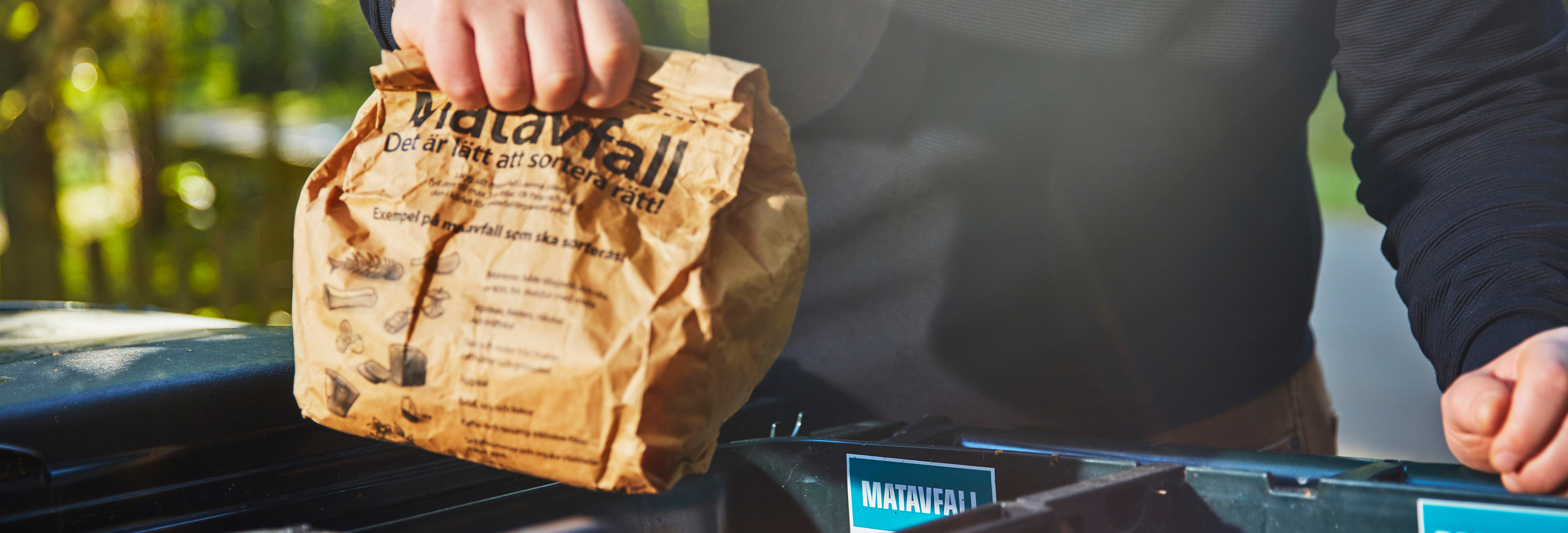 Man throwing food rubbish in bin