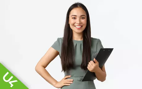 Smiling woman, holding a clipboard