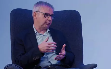 Man with glasses sitting in a chair