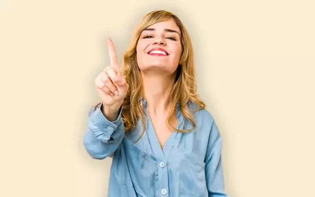 woman smiling and pointing number one