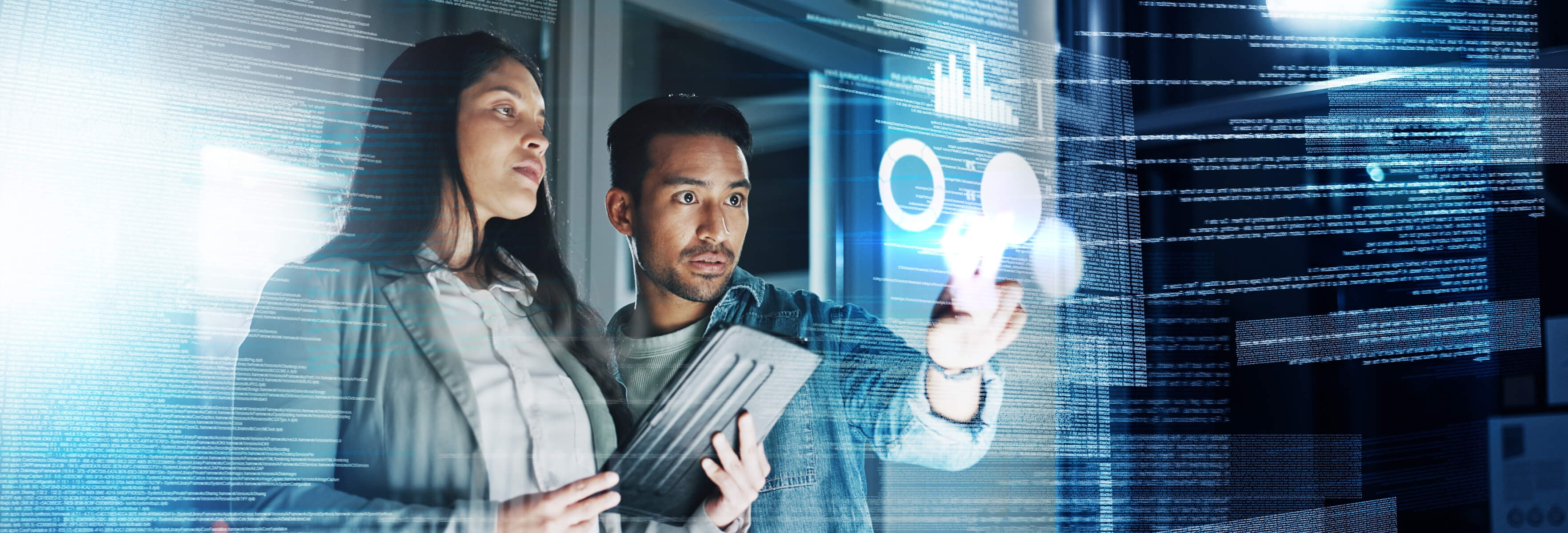 Two people interacting with futuristic holographic interfaces, analyzing data and charts in a high-tech office environment.