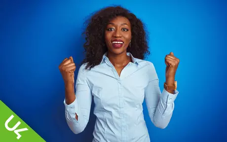 Woman smiling and with both hands half raised in celebration