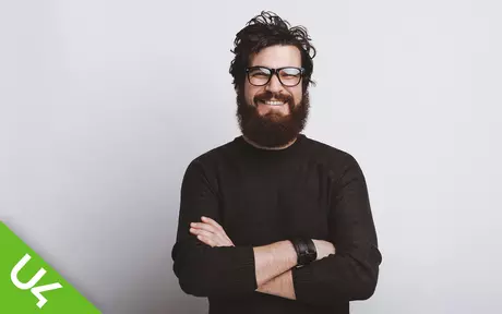 Smiling man with arms folded