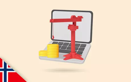 Laptop with coins and a building crane