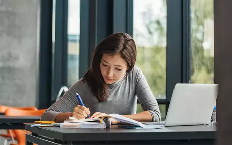person studying with laptop