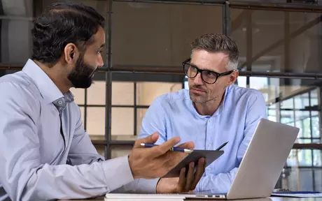 Two men talking together 