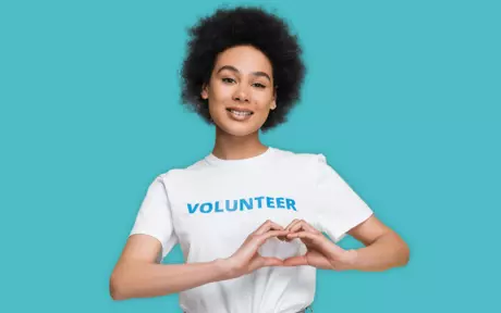 volunteer woman making heart with hands