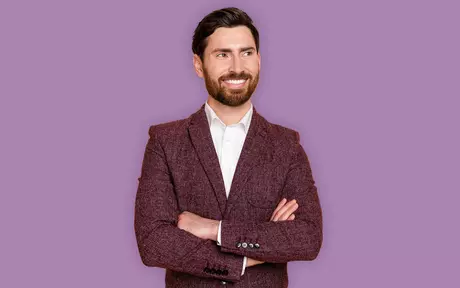 men smiling with purple background