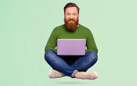 men with a laptop flying and smiling