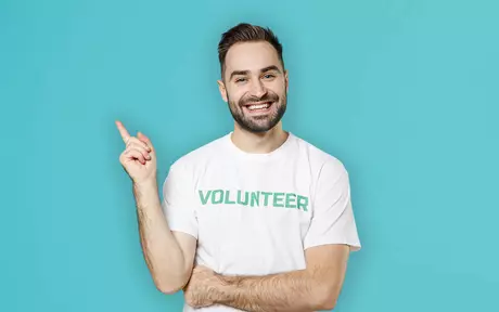 men pointing using a volunteer t-shirt