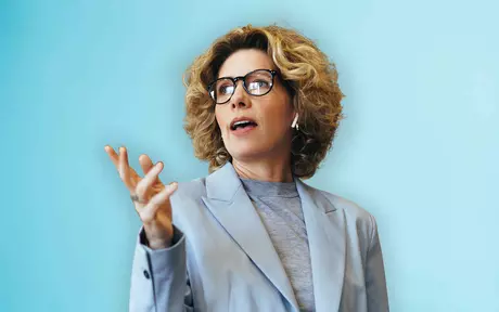 woman pointing with a blue background