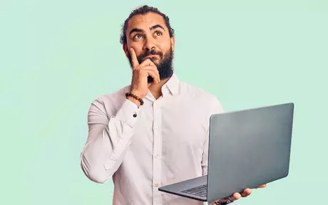 men thinking with a laptop in his hand