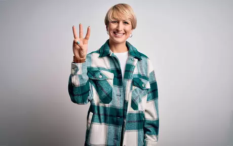 woman showing 3 fingers