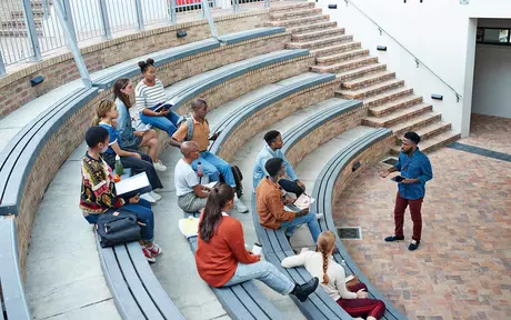 students sat in an auditorium listening to their tutor