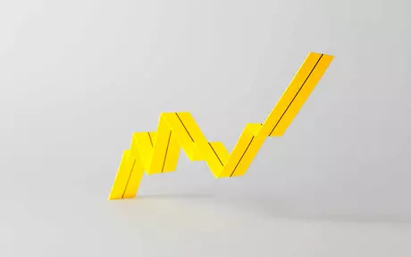 a 3 dimensional bar chart in yellow showing a steady increase on a grey background