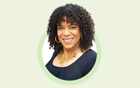 Portrait of Jennifer Sherman, Unit4's Chief Product Officer, smiling with curly hair, wearing a black top and a gold necklace, set against a light green circle and a beige background.