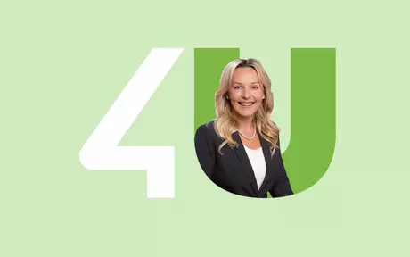 woman in black jacket inside unit4 logo