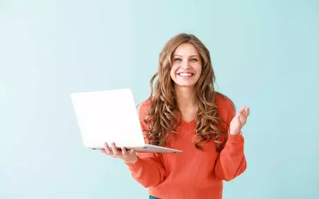 girl in red sweatshirt holding a laptop