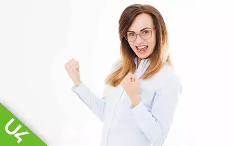 Smiling woman with both arms half raised and fists clenched in celebration