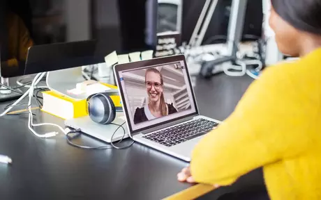 woman doing online webinar in her laptop